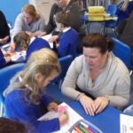 parent and child doing lessons at a desk